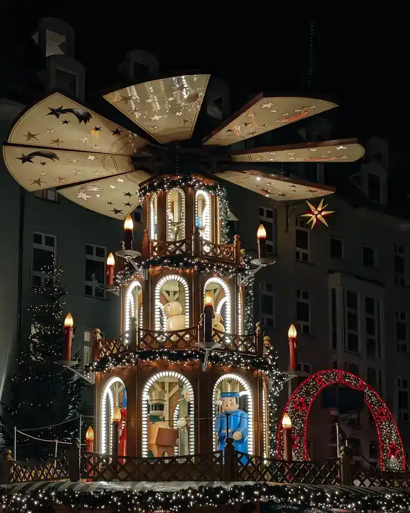 Giant illuminated wooden Christmas pyramid at Dresden's Christmas market at night