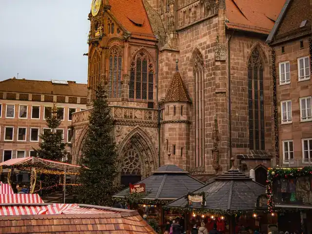 Red and white striped stall roofs in front of the Frauenkirche at Nuremberg's Christmas market