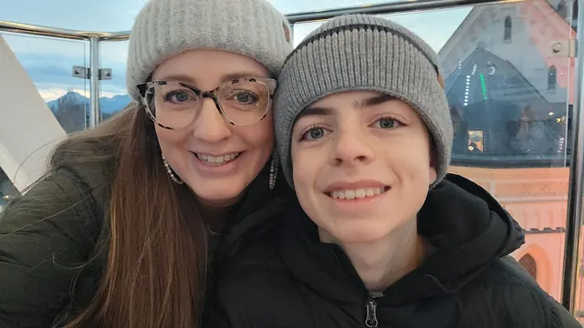 Shauna and Elijah smiling in a Ferris wheel gondola at the Rosenheim Christmas market