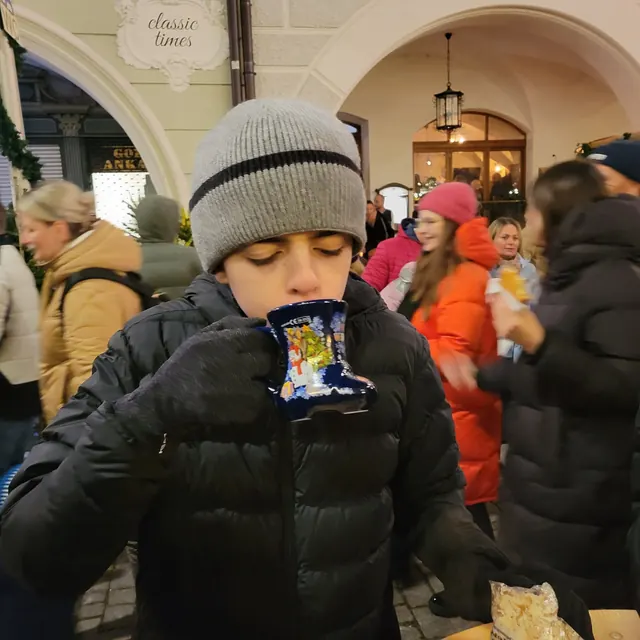 Elijah sipping from a Kinderpunsch mug at the Rosenheim Christmas market