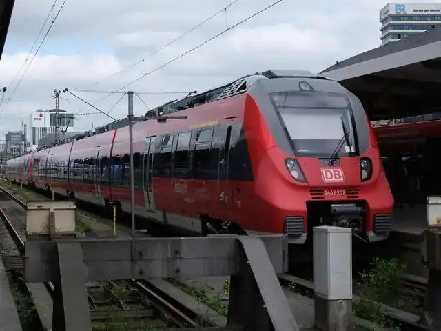 Red regional train waiting at a platform in Munich
