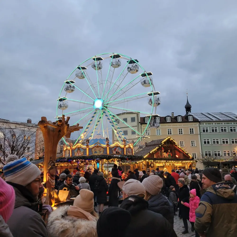 Ferris wheel and lit stalls at the Rosenheim Christkindlmarkt in December.